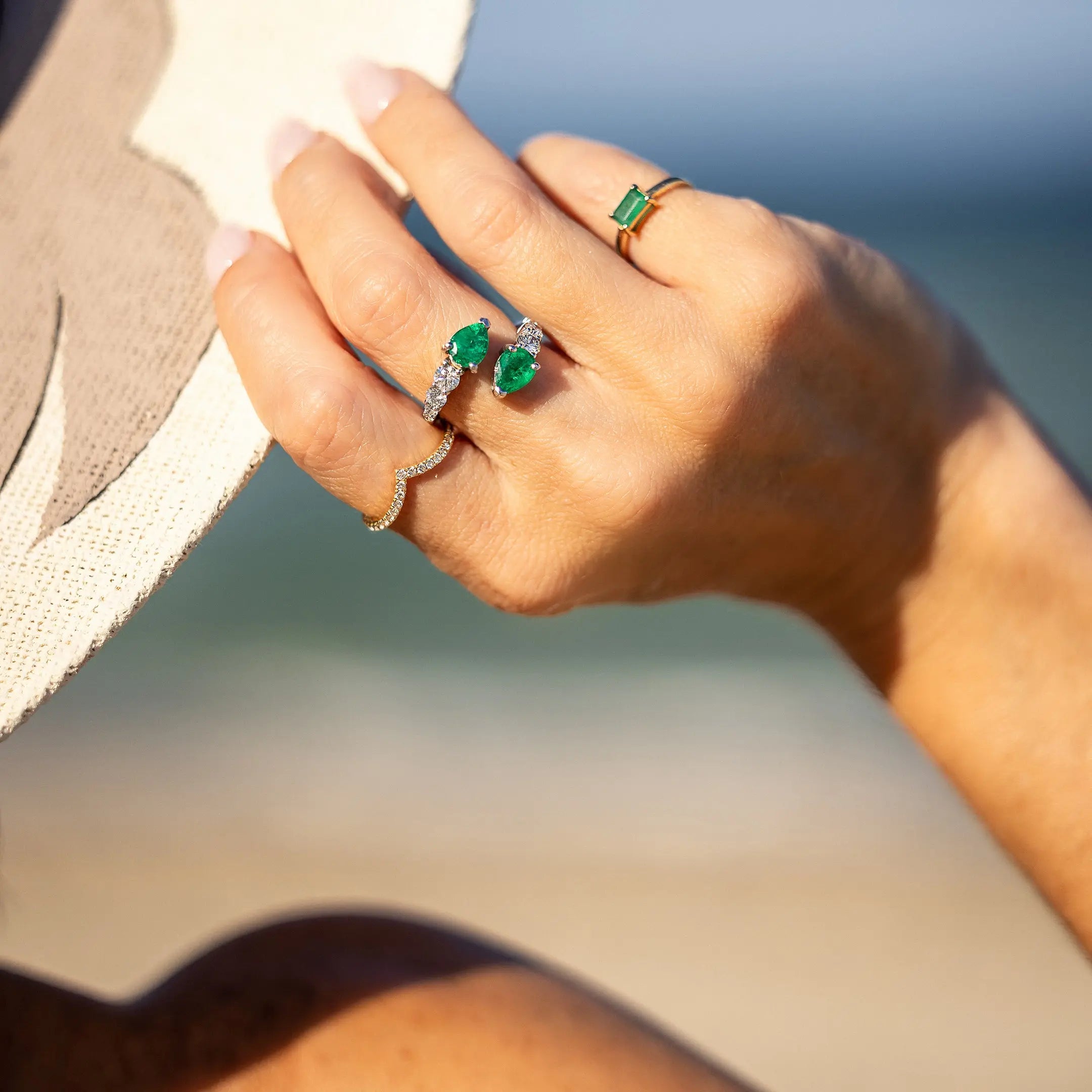 18K white gold open ring with pear emeralds and diamonds