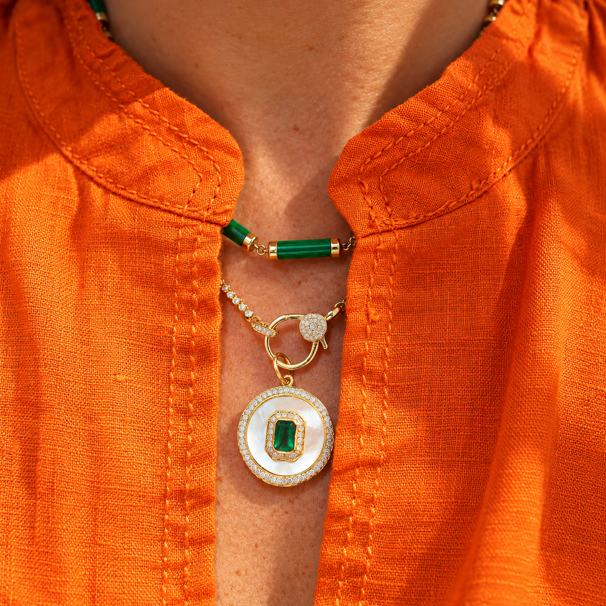 Emerald & Mother-of-Pearl Medallion Pendant with Diamonds in 14K Yellow Gold, worn with a green bead necklace | JJ Jewelry Miami