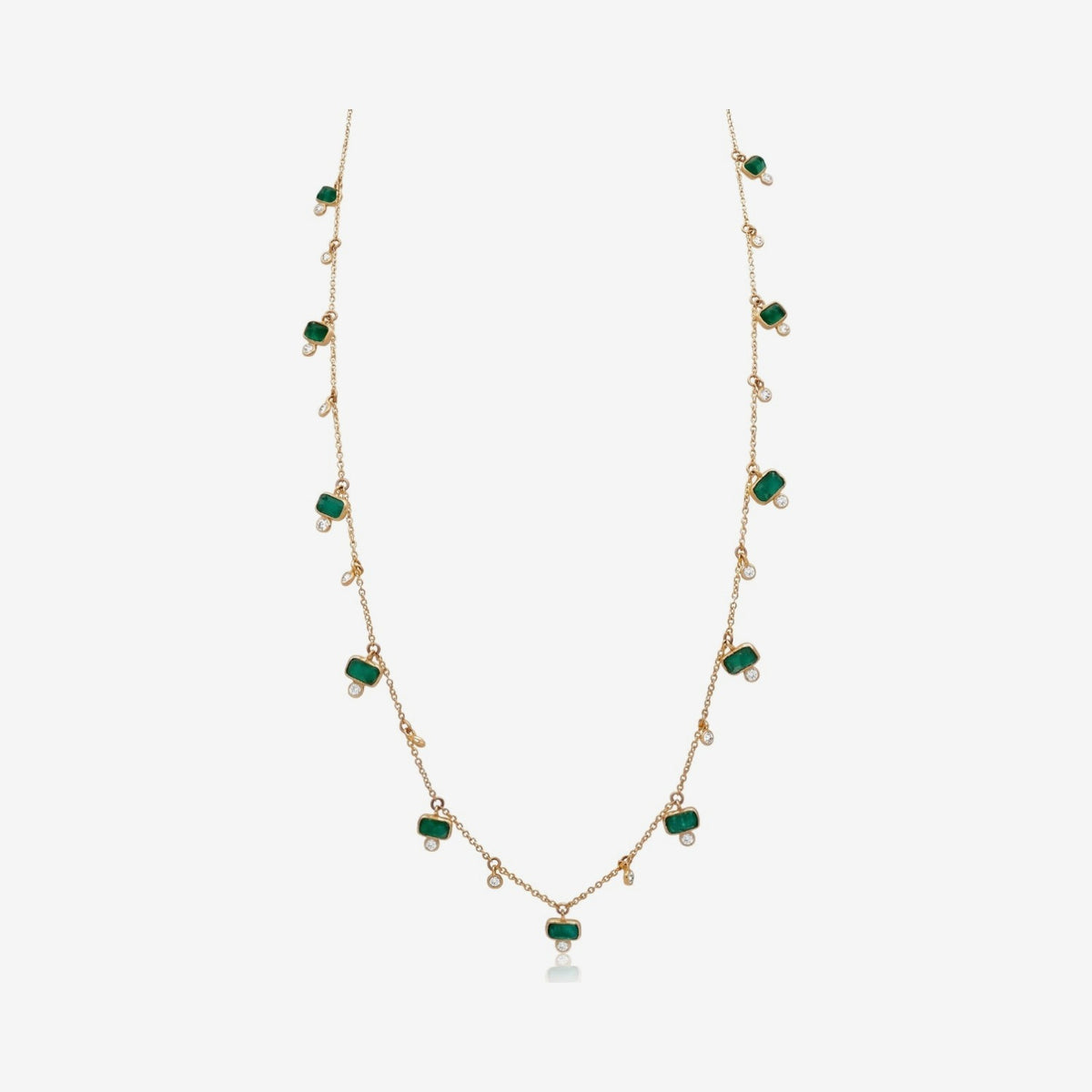 Emerald and Diamond Drop Station Necklace in 14K Yellow Gold, gray background | JJ Jewelry Miami