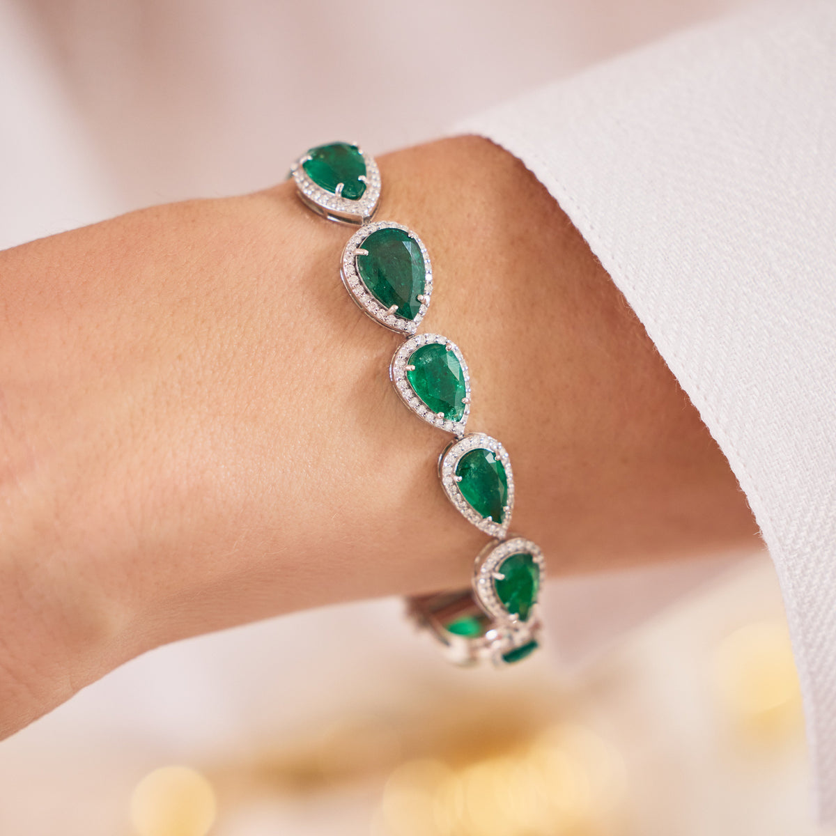 Pear Emerald and Diamond Halo Bracelet in White Gold, lifestyle view 1 | JJ Jewelry