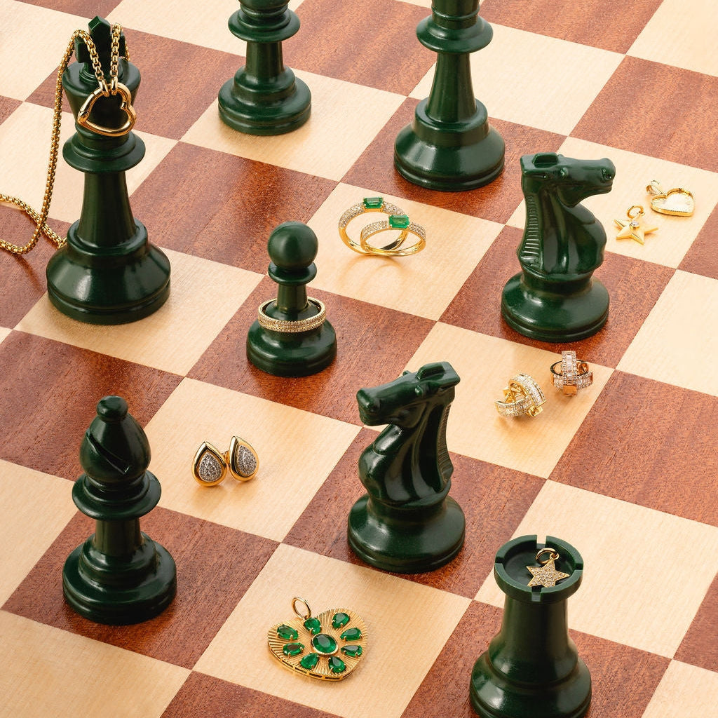 Puffed Gold Star Pendant with Diamond in 14K Yellow Gold, styled with fine jewelry on a chessboard | JJ Jewelry Miami