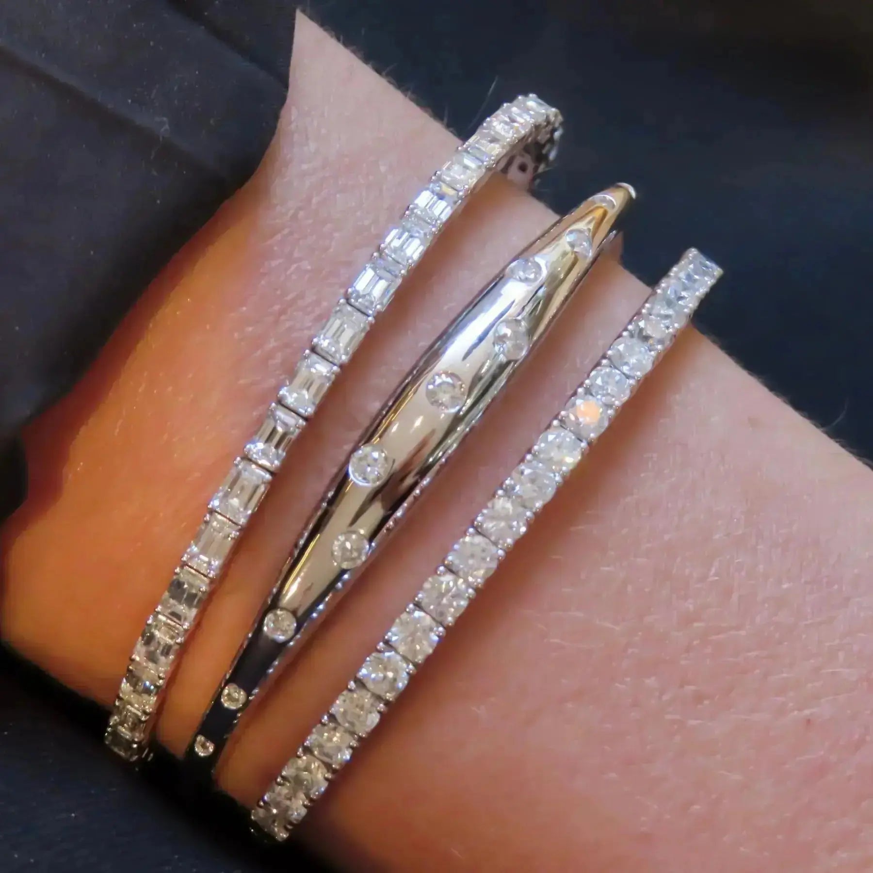 White gold diamond bracelet alternating emerald and round cuts