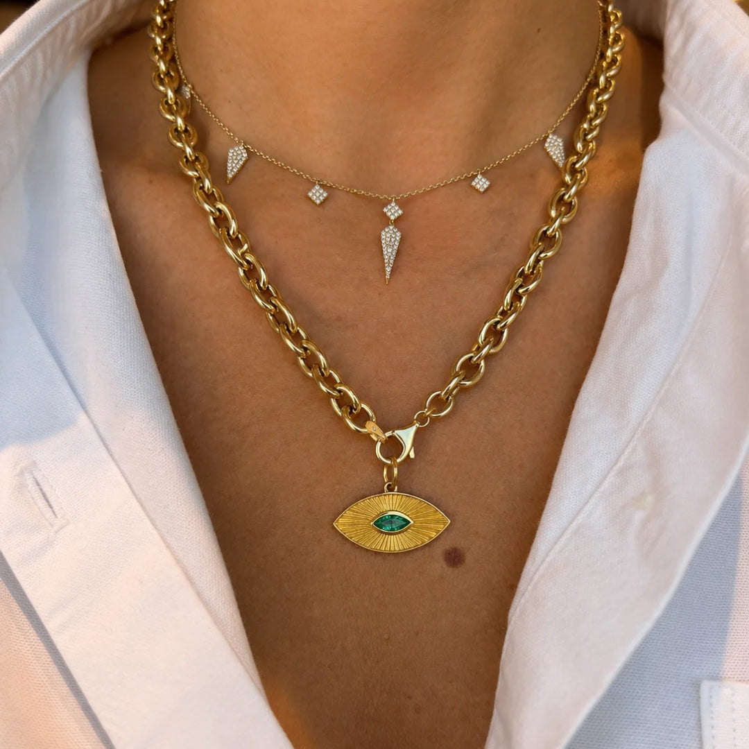 Emerald Sunray Eye Pendant in 14K Yellow Gold, layered on chunky gold chains | JJ Jewelry Miami