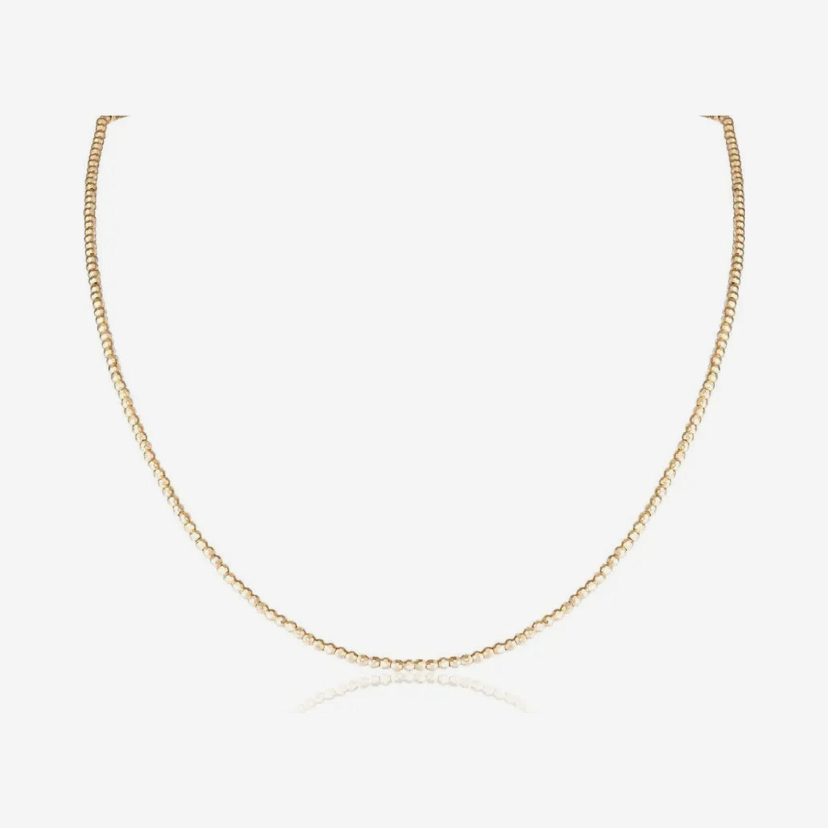 Faceted Bead Chain Necklace in 14K Yellow Gold, gray background | JJ Jewelry Miami