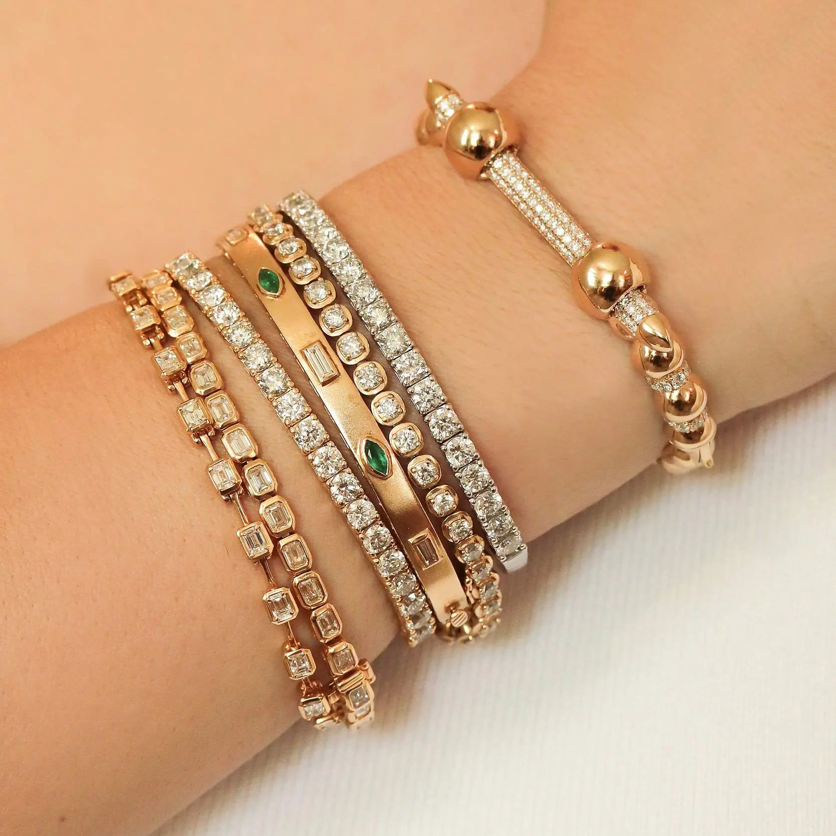 Fine jewelry bezel-set emerald diamond bangle modern elegant style