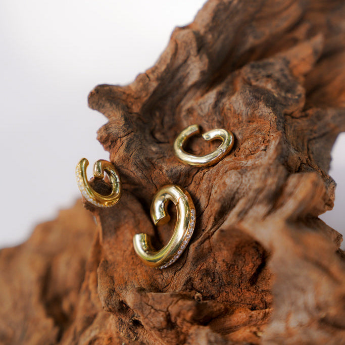 Diamond Circle Ear Cuff in 18K Yellow Gold, still life on wood | JJ Jewelry Miami