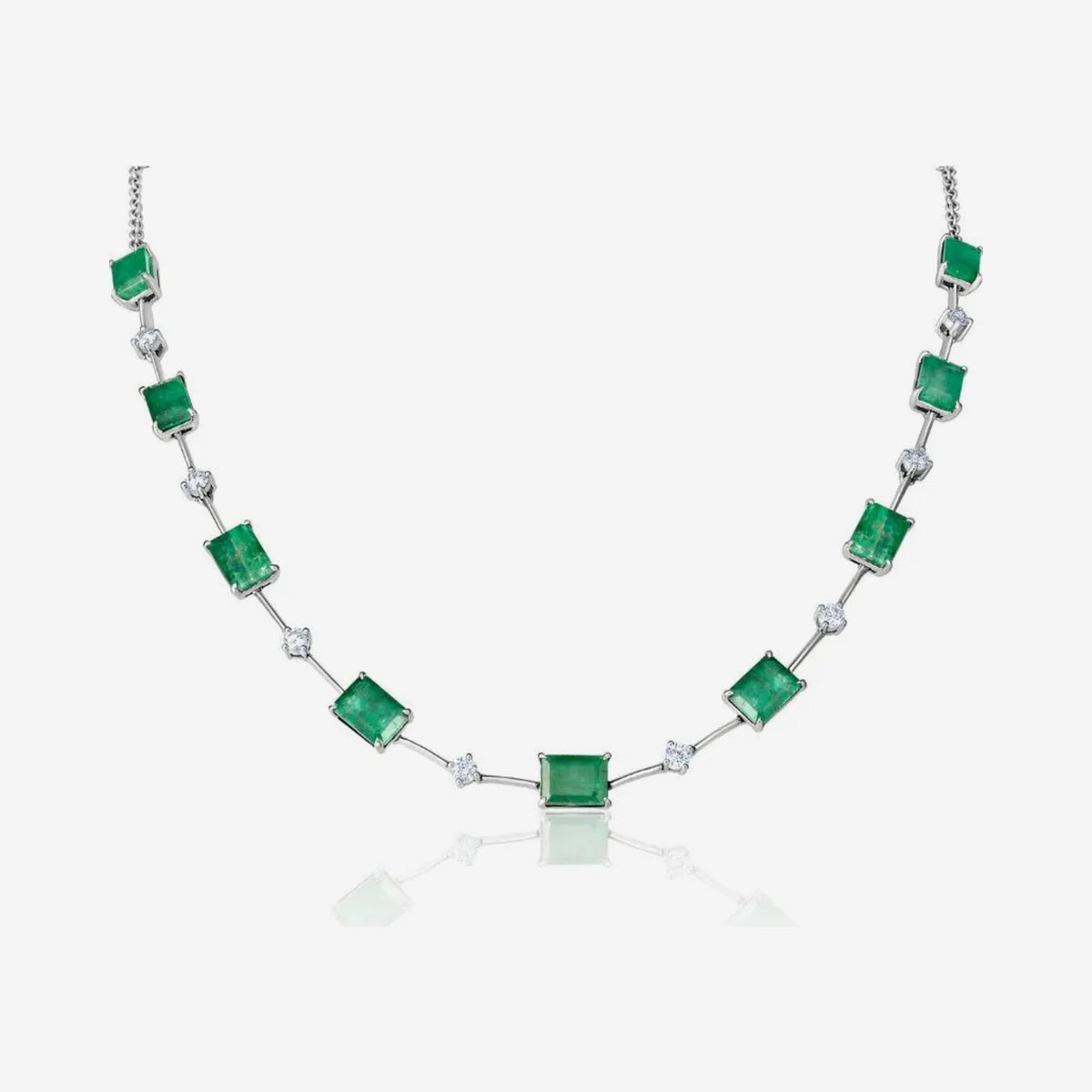 Emerald and Round Diamond Necklace in 18K White Gold, gray background | JJ Jewelry Miami