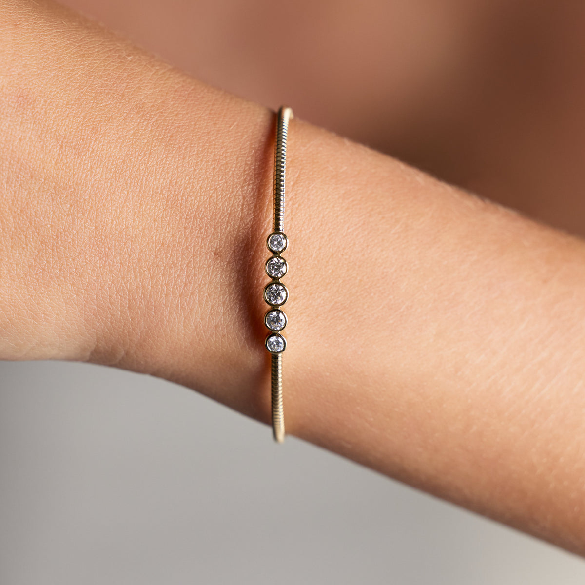 Five-Stone Diamond Flexible Bangle in Yellow Gold, lifestyle view 1 | JJ Jewelry