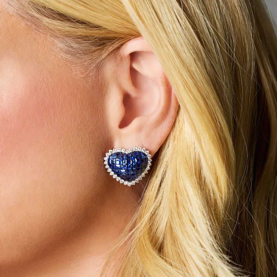 Heart-Shaped Blue Sapphire Earrings with Diamond Halo, on ear | JJ Jewelry Miami