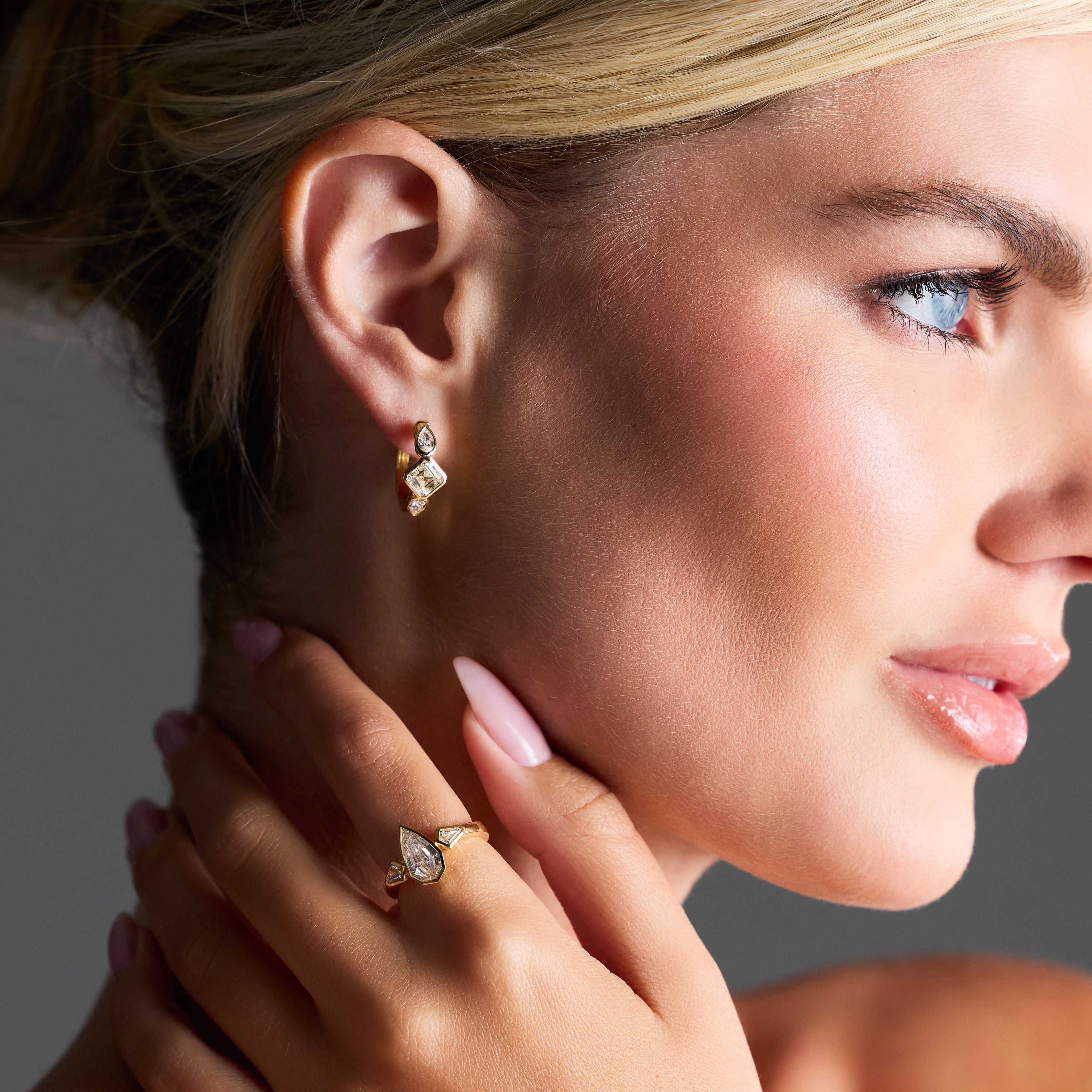 Close-up of diamond huggies featuring mixed shapes on ear