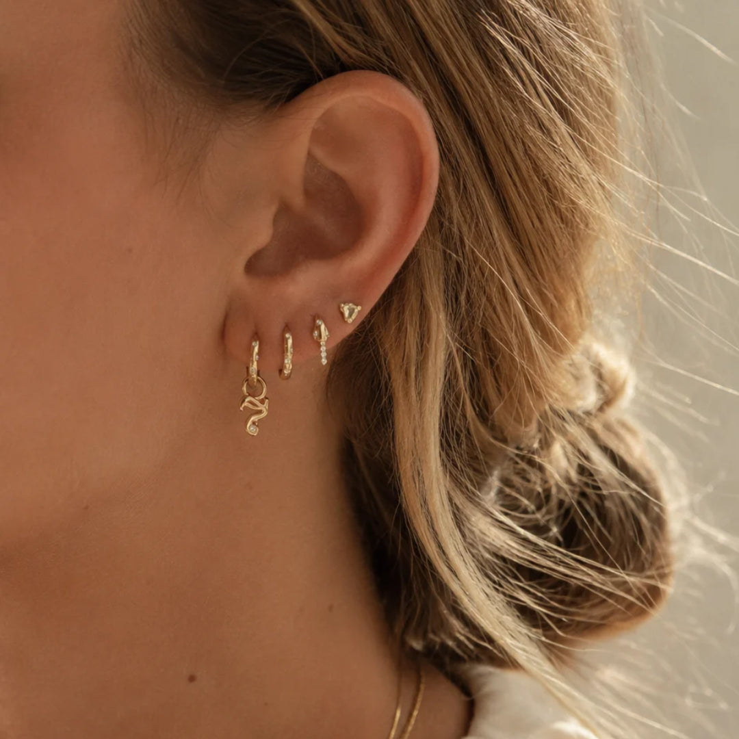 Mini Diamond Number Charm by Alessa Rocks in 18K Yellow Gold, worn on a huggie in an ear stack | JJ Jewelry
