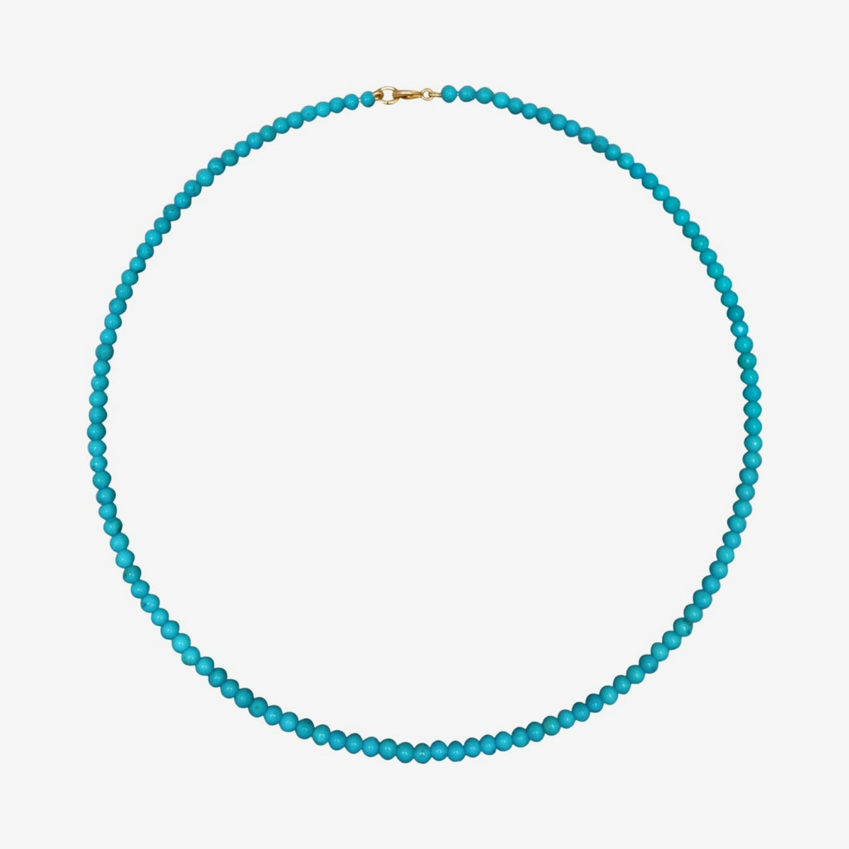 Turquoise Bead Necklace with 14K Yellow Gold clasp, gray background | JJ Jewelry Miami